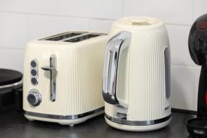 a white toaster sitting on top of a counter at Bright and Cozy Studio Flat for a Relaxing Stay in Greenford