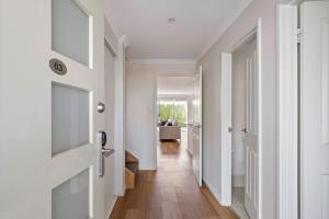 a hallway with a door with a television on it at 63@CapeView, Geographe bay in Busselton