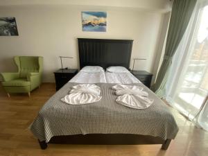 a bedroom with a bed with two pillows on it at Apartments 315 New Gudauri 2 blok in Gudauri +19 photos