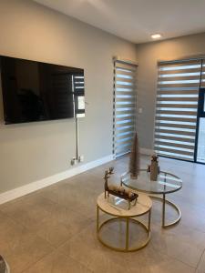 a living room with a table and a tv at Apartment in Alameda in Tijuana