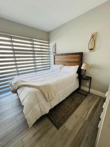 a bedroom with a large bed and a window at Apartment in Alameda in Tijuana +21 photos