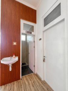 a bathroom with a sink and a door at Omah Ulfah Homestay in Banyuwangi +73 photos