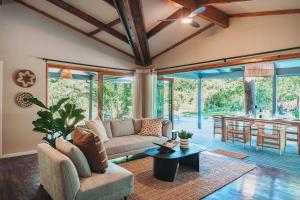 赫卢赫卢韦The Grand Luxury Safari Villa, Huge Private Pool, Hot tub, Outdoor Shower, Giraffe Tower, Free Standing Bath, Private Game Reserve, Stargazing, Ultimate Bush Luxury的客厅里有一张沙发和一张桌子。