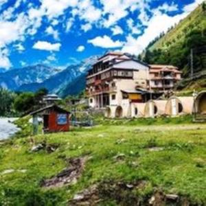 a large building in a field of green grass at Hotel Rest Inn in Dargai +18 photos