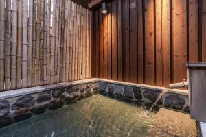 einen Wasserpool in einem Zimmer mit Holzwänden in der Unterkunft Jeju Sentosa Hallim in Jeju-do