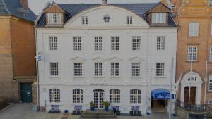 a large white building with a roof at Palads Hotel in Viborg