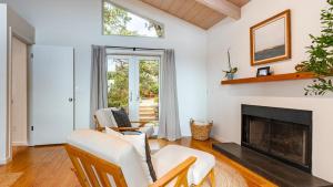 a living room with a fireplace and chairs at Sonoma Skyhouse by AvantStay Pool Sauna Hot Tub Stunning Valley Views in Sonoma +104 photos