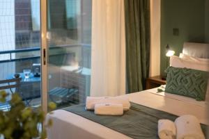 a hotel room with a bed with towels on it at Urban Nest in Kalamata