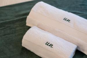 two towels sitting on top of a green table at Urban Nest in Kalamata