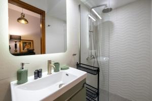 a white bathroom with a sink and a shower at Urban Nest in Kalamata +28 photos