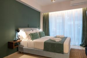 a bedroom with a large bed and a large window at Urban Nest in Kalamata