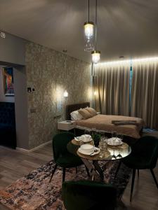 a room with a bed and a table and chairs at Svaja ApartHotel & SPA in Šiauliai