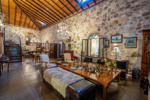 a large room with a table and chairs and a stone wall at simlarda aquapark otel in Ayvalık +160 photos