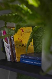 two books sitting on a shelf with grass at The Floating Terrarium in London