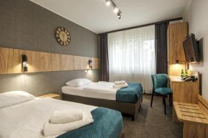 Ένα ή περισσότερα κρεβάτια σε δωμάτιο στο Hotel Olimp +24 φωτογραφίες