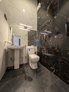 een badkamer met een wit toilet en een wastafel bij Kaveen Homes in Mount Lavinia