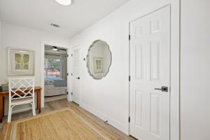 a hallway with a white door and a mirror at 322 S, 5th Street Unit A townhouse in Fernandina Beach