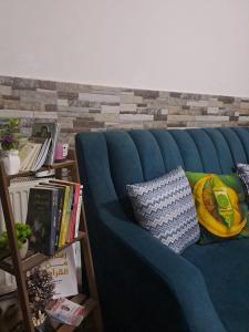 a blue couch with pillows on it in a room at شقة مميزة in Rujm Maghghijhah