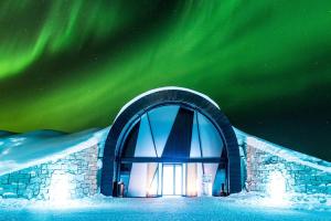 an igloo with the aurora in the sky at IceHotel in Jukkasjärvi