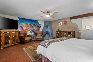 a bedroom with a large bed and a fireplace at Casas de Suenos Old Town Historic Inn, an Ascend Collection Hotel in Albuquerque +135 photos
