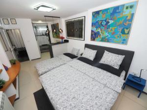 a bedroom with a bed and a couch at Galerija MARSHAL in Belgrade