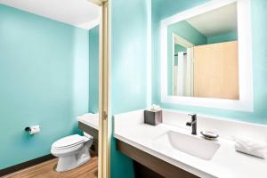 a bathroom with a white sink and a toilet at Maverick Hotel Eugene Near University, an Ascend Collection Hotel in Eugene +36 photos