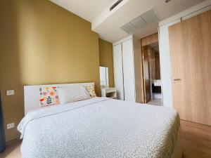 a bedroom with a bed with a white bedspread at Noble Bangkok Condo in Bangkok +24 photos