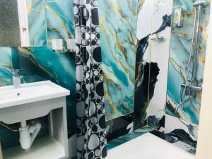 a bathroom with a shower curtain and a sink at Hotel Ravshanbek in Samarkand +38 photos