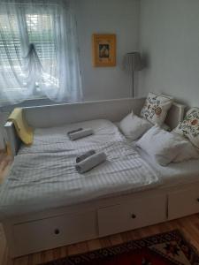 a large white bed with two remote controls on it at Ferienwohnung Fritz in Villach