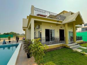 a house with a swimming pool in front of it at Staymist - Pool and Pause Villa in Nagaon