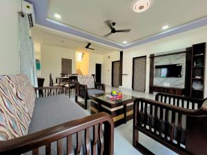 a living room with chairs and a couch and a television at Staymist - Pool and Pause Villa in Nagaon