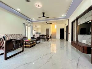 a living room with a couch and a table at Staymist - Pool and Pause Villa in Nagaon
