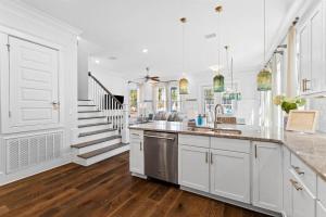 a white kitchen with a sink and a counter at It's a Shore Thing in Inlet Beach