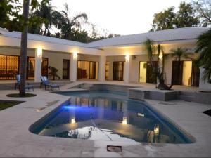 a house with a swimming pool in front of a house at White House River Manor in Upington