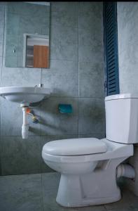 a bathroom with a white toilet and a sink at CK place in Nairobi