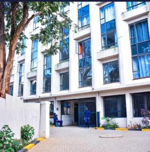 a person standing in front of a building at CK place in Nairobi