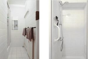 une salle de bain blanche avec une douche et un lavabo dans l'établissement Group-friendly Stay In Tilburg Walk To 013, à Tilbourg