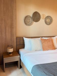 a bedroom with a bed and a side table at The H2O Khao Yai in Ban Rai Khlong Sai
