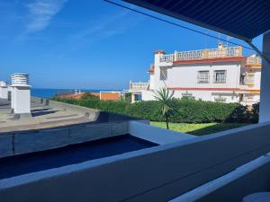 a view of the ocean from the balcony of a house at Apartahotel Estudio 332 in Matalascañas