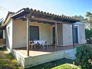 a house with a deck with a table at Villa del Alma in Planos