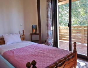 a bedroom with a bed and a large window at Villa del Alma in Planos