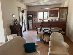a kitchen and dining room with a table and chairs at Villa del Alma in Planos +13 photos