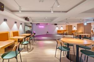 a room with tables and chairs and a stage at Moonsset INN Taitung in Taitung City