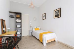 a small bedroom with a bed and a desk at Maison à Argelès in Argelès-sur-Mer