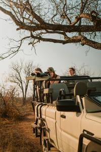 a group of people riding in the back of a vehicle at Khanya Conservation Camp in Phalaborwa