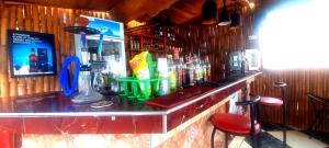 a bar with a counter with a lot of drinks at OSAK GUEST house in Midie