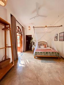 a bedroom with a bed with a mosquito net at La Sirena Villa in Talpe