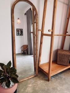 a mirror with a wooden frame in a room at La Sirena Villa in Talpe +7 photos