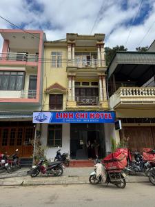 a group of motorcycles parked in front of a building at Linh Chi Hotel in Mù Cang Chải