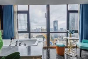 a large bathroom with a tub and a large window at VKing High-Altitude River View Hotel in Nan'an +1 photo
